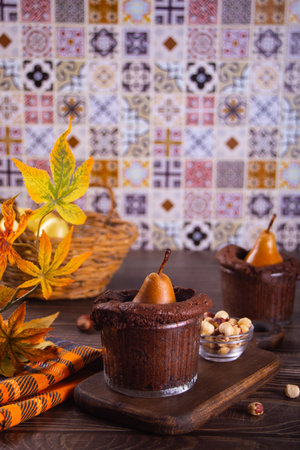 Sweet homemade autumn spicy biscuit mini pie in cup with whole pear and nutsの写真素材