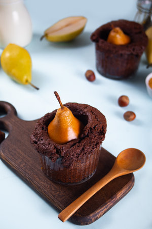 Sweet homemade chocolate biscuit mini pie in cup with whole pear and nutsの写真素材