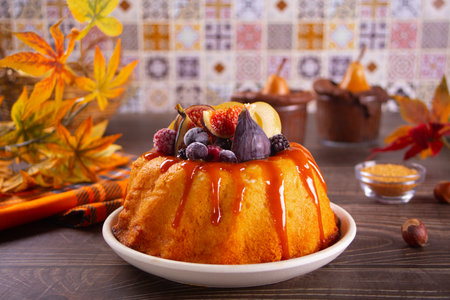 Delicious homemade autumn cake with figs and frozen berries for celebrating Thanksgiving day or Halloween.の写真素材