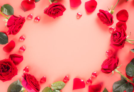 Frame of red roses and heart on pink background. top view. copyspace. valentines day conceptの写真素材