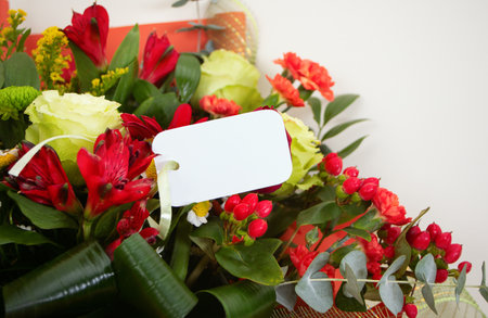 Bouquet of flowers and empty tag on white background. Wedding. Mothers Day. Valentines Day. Birthday. Happy womans day.の写真素材