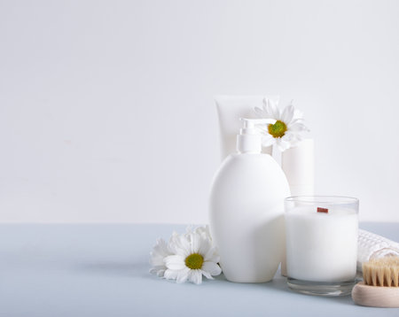 Blank mock up bottles beauty cosmetic skin care organic product for bathing routine with flowers chamomile. Place your design.の写真素材