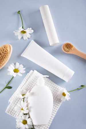 Blank mock up bottles beauty cosmetic skin care organic product for bathing routine with chamomile flower. Place your design. Top viewの写真素材