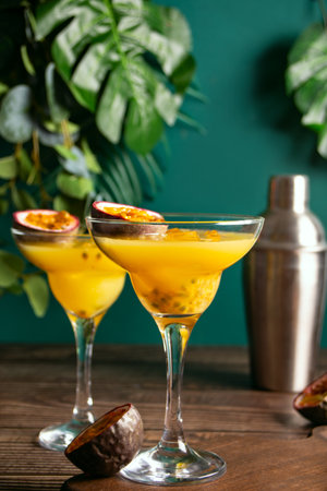 Fresh passion fruit maracuja alcoholic cocktail with ice cubesの写真素材