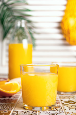 Fresh orange juice on table with slices fruits.の写真素材
