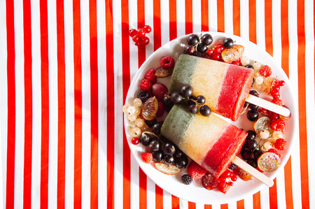Homemade tasty vegan berries ice cream layered colorful  . summer dessert. top view.の素材