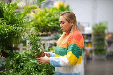 Woman at a garden center buying home plant.の写真素材
