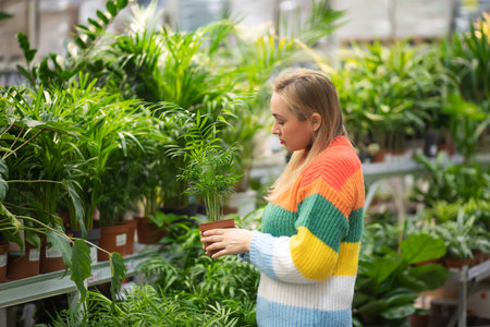 Woman at a garden center buying home plant.の写真素材