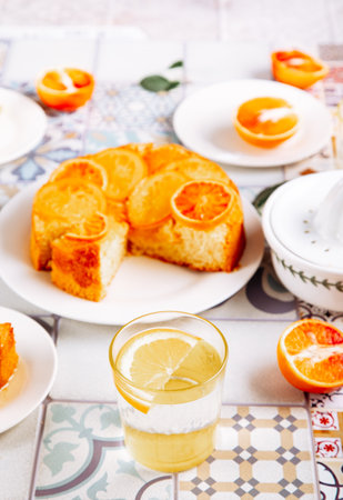 Glass of fresh lemonade and orange cake with fruit citrus slicesの写真素材