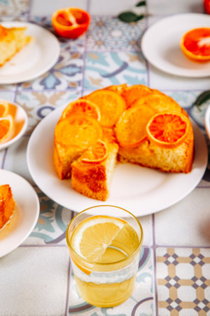 Glass of fresh lemonade and orange cake with fruit citrus slicesの写真素材