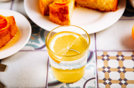 Glass of fresh lemonade and orange cake with fruit citrus slicesの写真素材