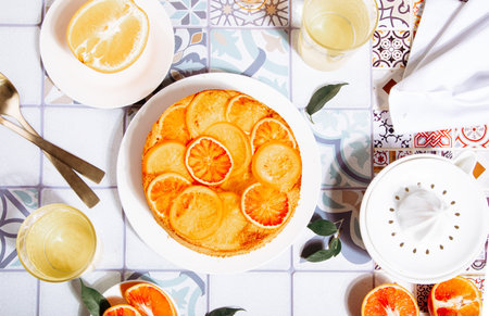 Orange cake with fruit citrus slices on the plate. Top view.の写真素材
