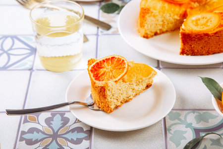 Orange cake with fruit citrus slices on the plateの写真素材