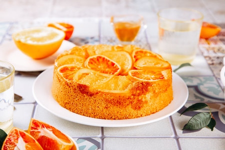 Orange cake with fruit citrus slices on the plateの写真素材