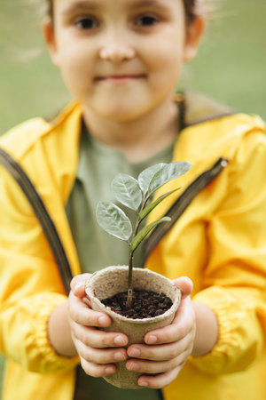 Kid child hands holding pot with plant. Save the Earth. Earth Day. World Environment Dayの写真素材