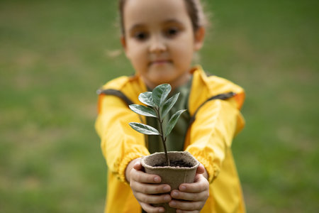 Kid child hands holding pot with plant. Save the Earth. Earth Day. World Environment Dayの写真素材
