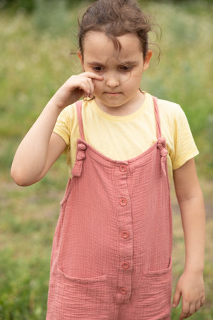 Sad, Serious pensive little kid girl preschool child crying unhappy looking at camera. Negative emotionsの写真素材
