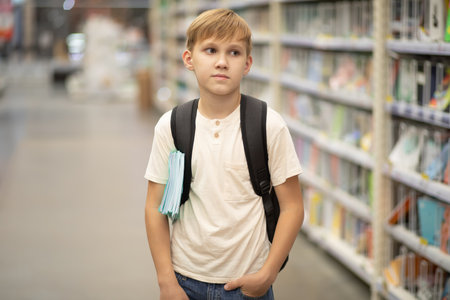 Cute kid boy choosing school stationery.の写真素材
