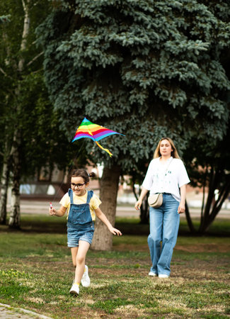 Little cute girl running with kite on summer day in the park outdoor. Summer outdoor activityの写真素材