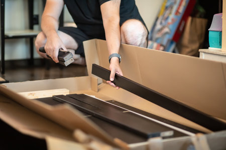 The man handyman is engaged in assembling the cupboard