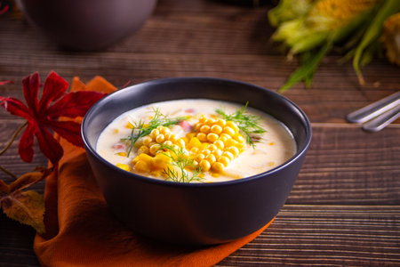 Delicious creamy corn soup in a bowl. Autumn food. Harvest concept.
