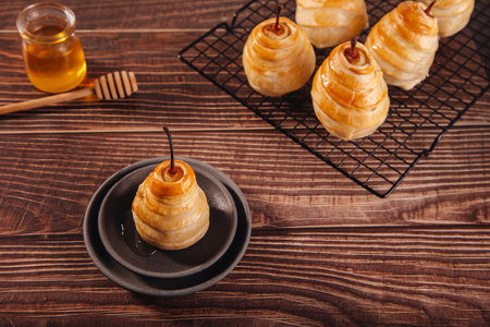 Pears in puff pastry dough drizzled with honey. Healthy and organic food.の写真素材
