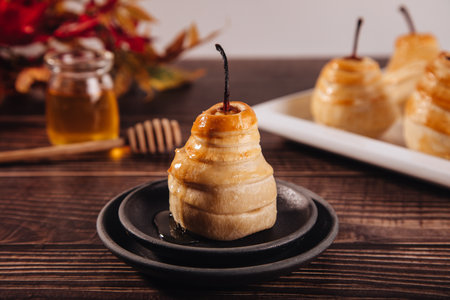 Pears in puff pastry dough drizzled with honey. Healthy and organic food.の写真素材