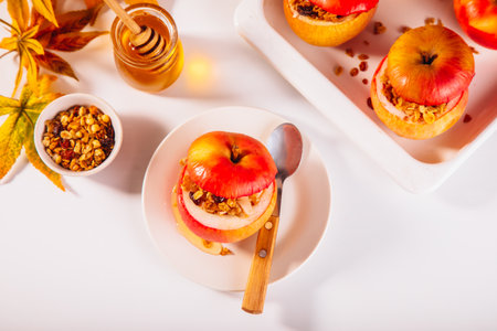 Sweet autumn dessert baked apples stuffed with muesli, nuts and honey.の写真素材