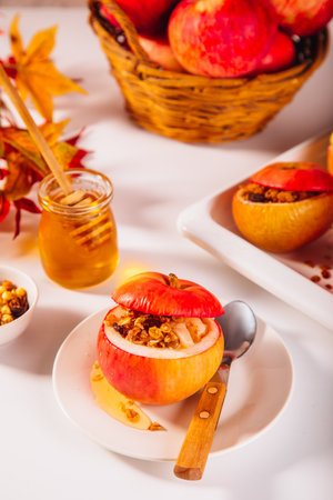 Sweet autumn dessert baked apples stuffed with muesli, nuts and honey.の写真素材