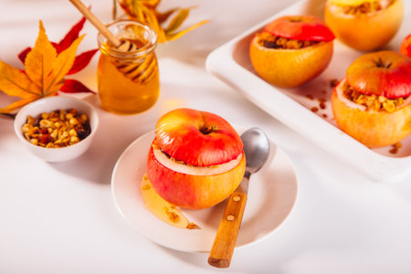 Sweet autumn dessert baked apples stuffed with muesli, nuts and honey.の写真素材