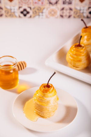 Pears in puff pastry dough drizzled with honey. Healthy and organic food