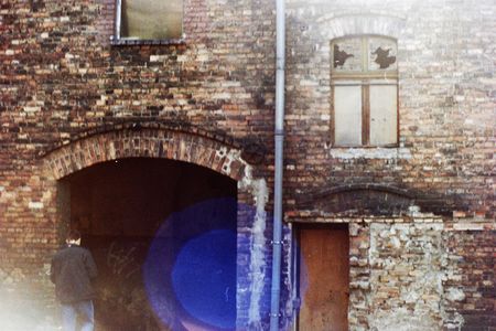 Broken windows in a derelict red brick building.の写真素材