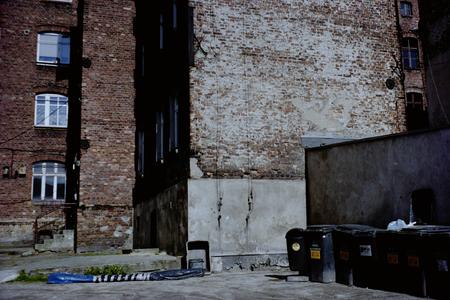 Trash in the courtyard. Red brick slums.の写真素材