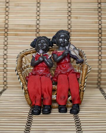 two musician girls on a wooden chairの写真素材