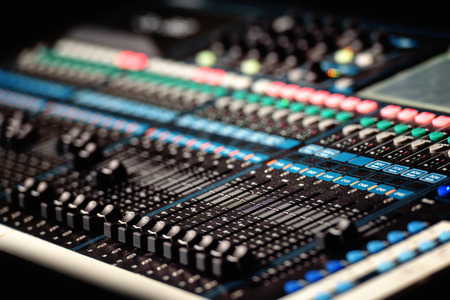 Finger adjusting audio mixer in studioの写真素材