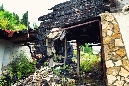 Burnt out house with charred roof and burnt furnitureの写真素材