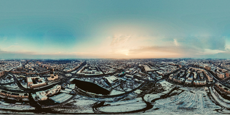360 panorama of Sun shining over winter city with sun rays hitting the buildingsのeditorial素材