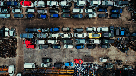 Damaged cars waiting in a scrapyard to be recycled or used for spare part