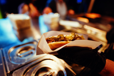 Serving street food at night at a festivalの写真素材