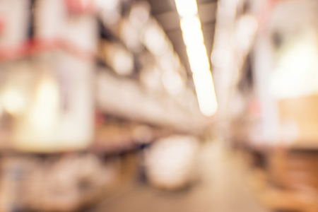 Defocused background of industrial warehouse interior aisle. inventory, hypermarket, wholesale, logistic and export conceptの写真素材