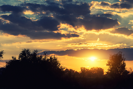 Dramatic colorful sky with clouds at sunsetの写真素材