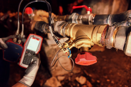 Heating engineer repairing and maintaining heating systemの写真素材