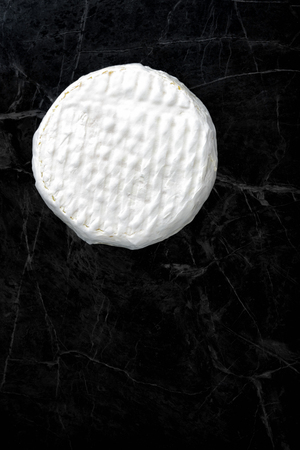 Brie cheese on dark backgroundの写真素材