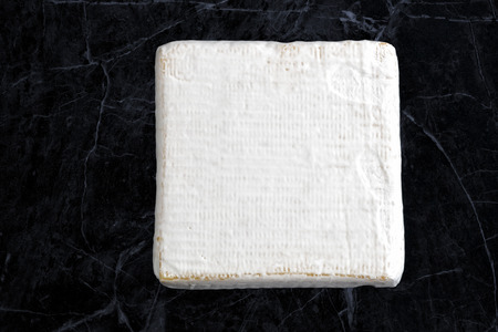 Brie cheese on dark backgroundの写真素材
