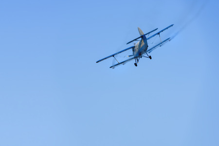 Airplane flying in the sky spraying mosquitoeのeditorial素材