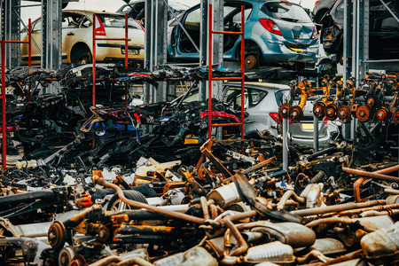 Damaged cars waiting in a scrapyard to be recycled or used for spare partのeditorial素材