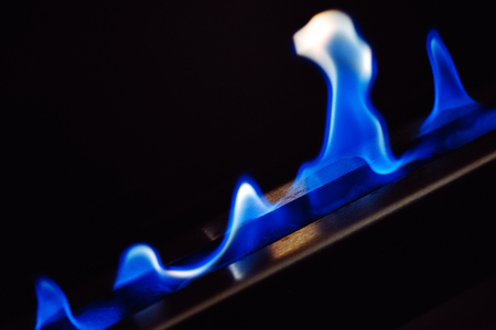 Blue flames of a gas stove modern fireplaceの写真素材