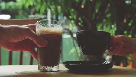 girl and man takes a latte and iced coffee
