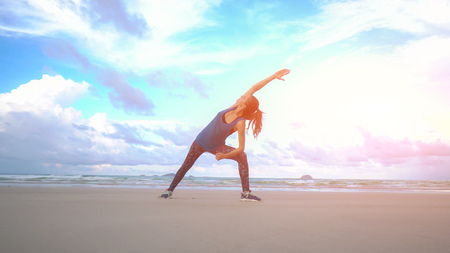 Woman is making yoga pose on beach in Vietnam. Sea or ocean happy female relaxation. Water and...