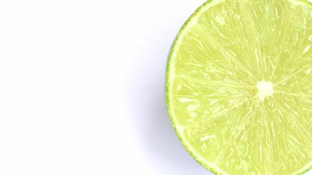 The cut lime slice on a white background.